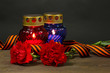 Memory lantern with candles, red carnations and St. George