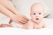 Foto: Mother massaging baby Mother massaging baby