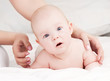 Mother massaging  baby