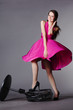 young beautiful girl in pink dress on the fan