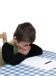 Foto: Child struggling with homework. Child struggling with homework.