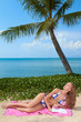 Woman reading on a tropical beach