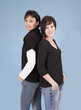 Sisters standing back against each other