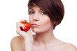 Young caucasian girl with tomato