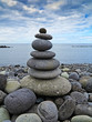 stack of stones on the beach and sea background stack of stones on the beach and sea background