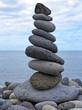 stack of pebbles on the beach and sea background stack of pebbles on the beach and sea background