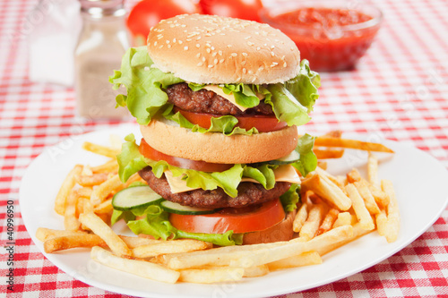 Photo: Double hamburger with cheese, lettuce and tomato Double hamburger with cheese, lettuce and tomato