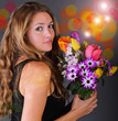 Young, happy woman with a colorful bouquet of spring flowers