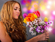 Young happy woman with a colorful bouquet of spring flowers