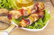 Pieces of salmon on skewers with vegetables