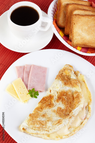 Photo: Breakfast. Omelette with cheese and ham Breakfast. Omelette with cheese and ham