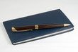 pen on checkbook over white