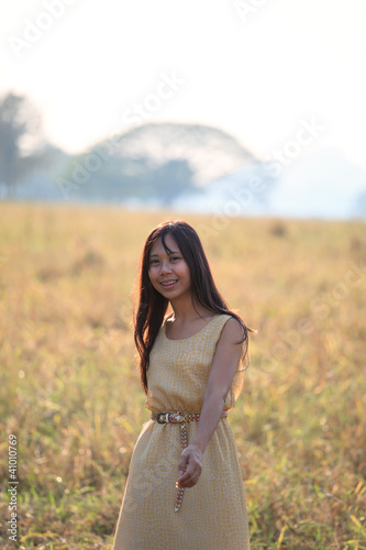 Photo: face of women standing in the grass field with evening light face of women standing in the grass field with evening light