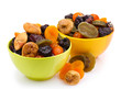 Dried fruits in bright bowls isolated on white