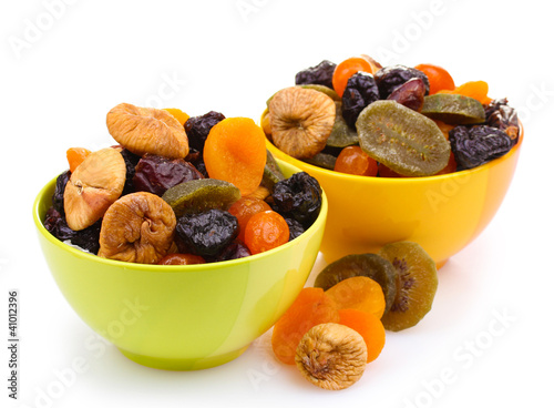 Photo: Dried fruits in bright bowls isolated on white Dried fruits in bright bowls isolated on white