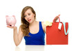 Woman with piggybank and shopping bags