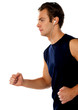 Fit athlete enjoying music in a jogging posture