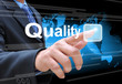 businessman hand pushing quality button