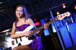 Young guitar player performing in night club