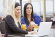 Girls in restaurant with laptop