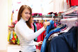 Young woman inside a store buying clothes