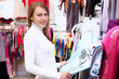 Young woman inside a store buying clothes