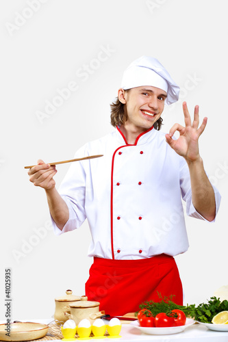 Photo: Portrait of a young cook in uniform Portrait of a young cook in uniform