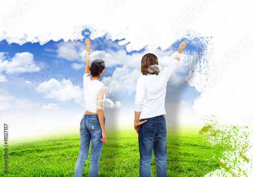 Photo: Young couple with paint brushes together Young couple with paint brushes together