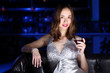 Young woman in night club with a drink