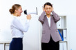 Young woman with megaphone in office Young woman with megaphone in office
