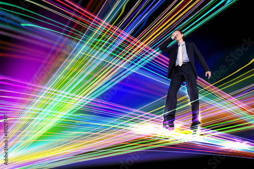 Photo: Businessman walking over Internet lines Businessman walking over Internet lines
