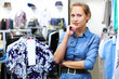 Woman in a shop buying clothes