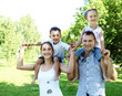 Photo: Family with two children in the summer park Family with two children in the summer park