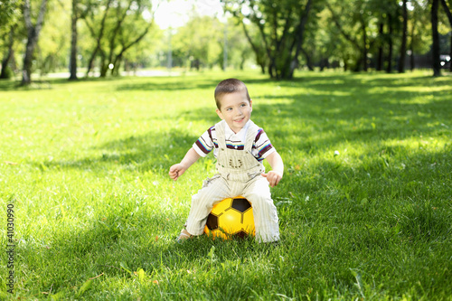 Photo: Little boy in the park playing with a ball Little boy in the park playing with a ball