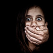 Girl being abused by a man hiding in the shadows