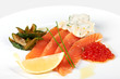 Slices of red fish with caviar and lemon