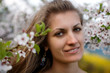 Young woman with spring flowers of sakura Young woman with spring flowers of sakura