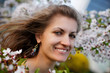 Young woman with spring flowers of sakura Young woman with spring flowers of sakura