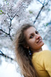 Young woman with flowers of sakura Young woman with flowers of sakura