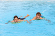 two friends swimming in the pool