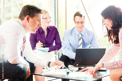 Photo: Business people having meeting in office Business people having meeting in office