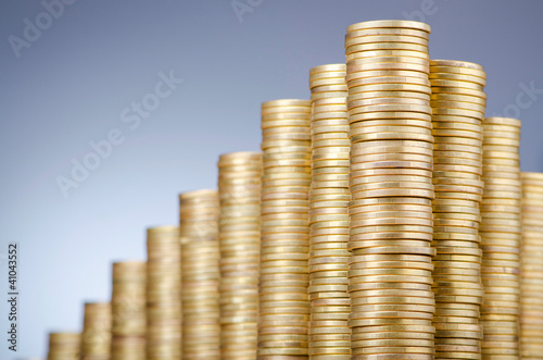 Photo: Golden coins in high stacks Golden coins in high stacks