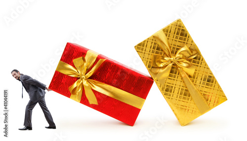 Photo: Businessman with gift boxes on white Businessman with gift boxes on white