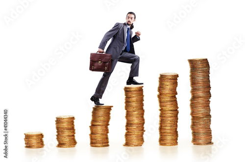 Foto: Businessman climbing gold coins stacks Businessman climbing gold coins stacks