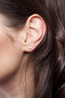 Photo: Young woman ear closeup Young woman ear closeup