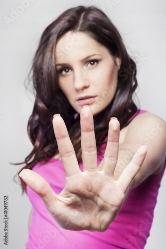 Photo: Young pretty woman making stop sign Young pretty woman making stop sign