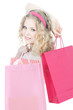 happy teenage girl with pink shopping bags