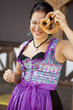 German girl wearing typical bavarian clothes holding breze