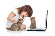 Funny child using a laptop over white background with kitten