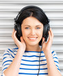 happy teenage girl in big headphones